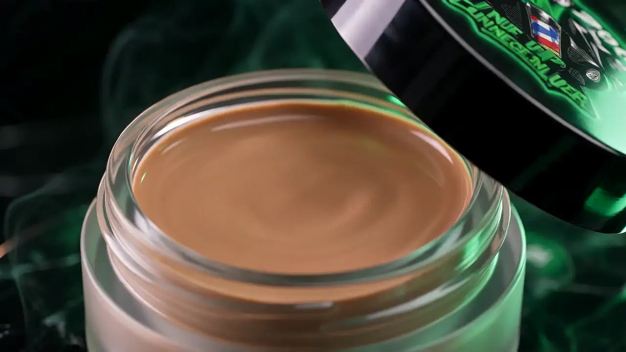Macro view of the concealer cream surface inside the glass jar