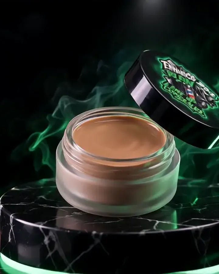 The Line Up Concealer jar open on a marble podium with its printed lid tilted beside it